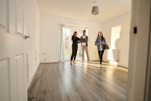 People looking at home's interior. 