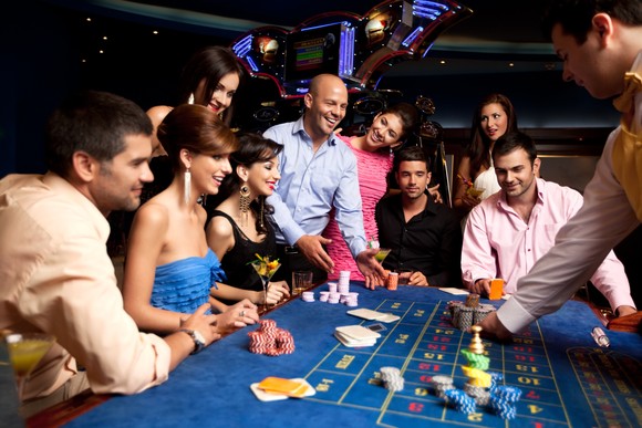 A group of people gambling at a table.