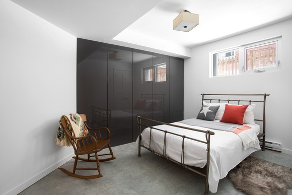 A bedroom in a basement apartment.