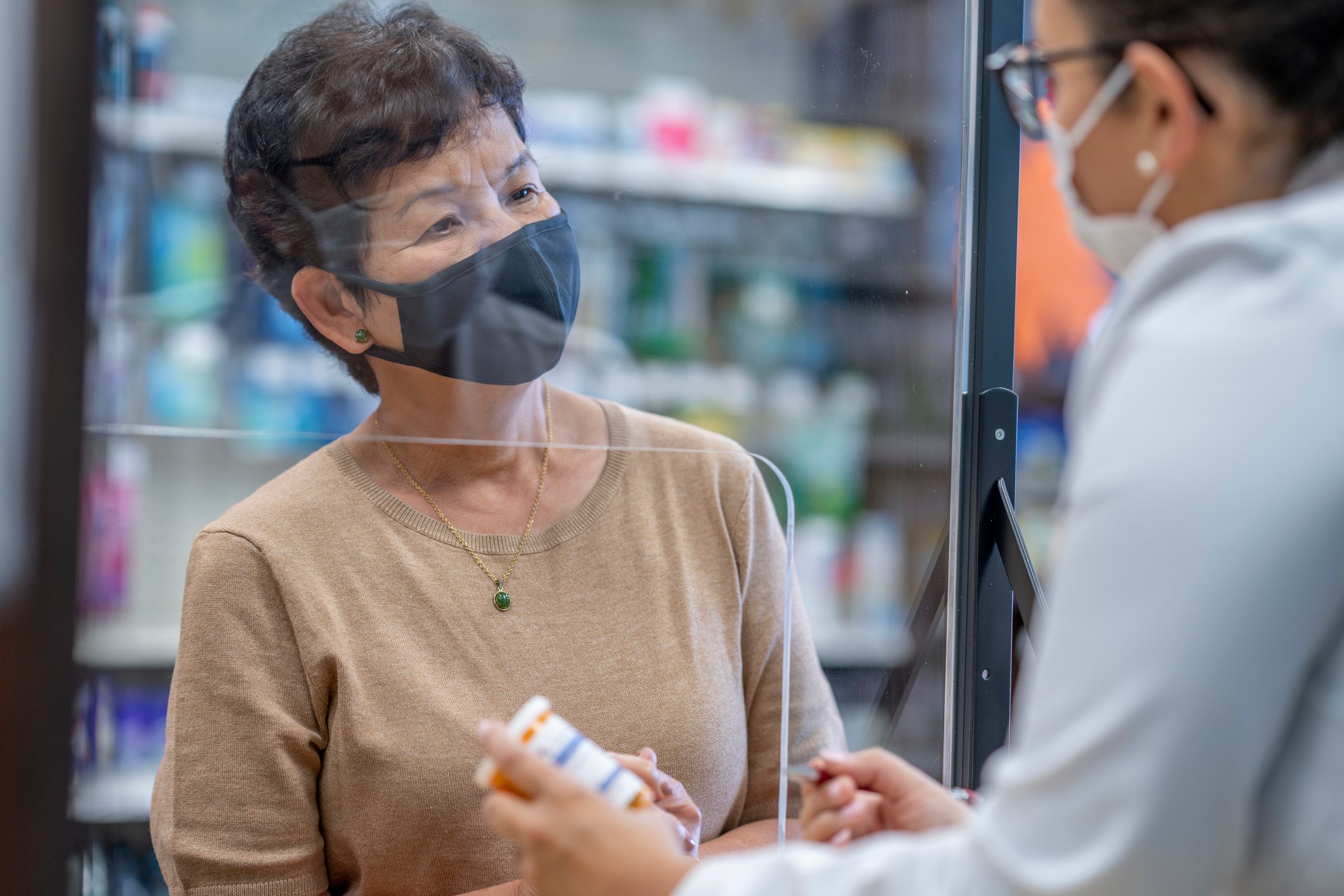 A person speaks with their pharmacist.