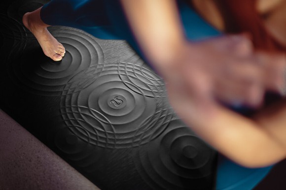 A yoga mat with the Lululemon logo printed on it.