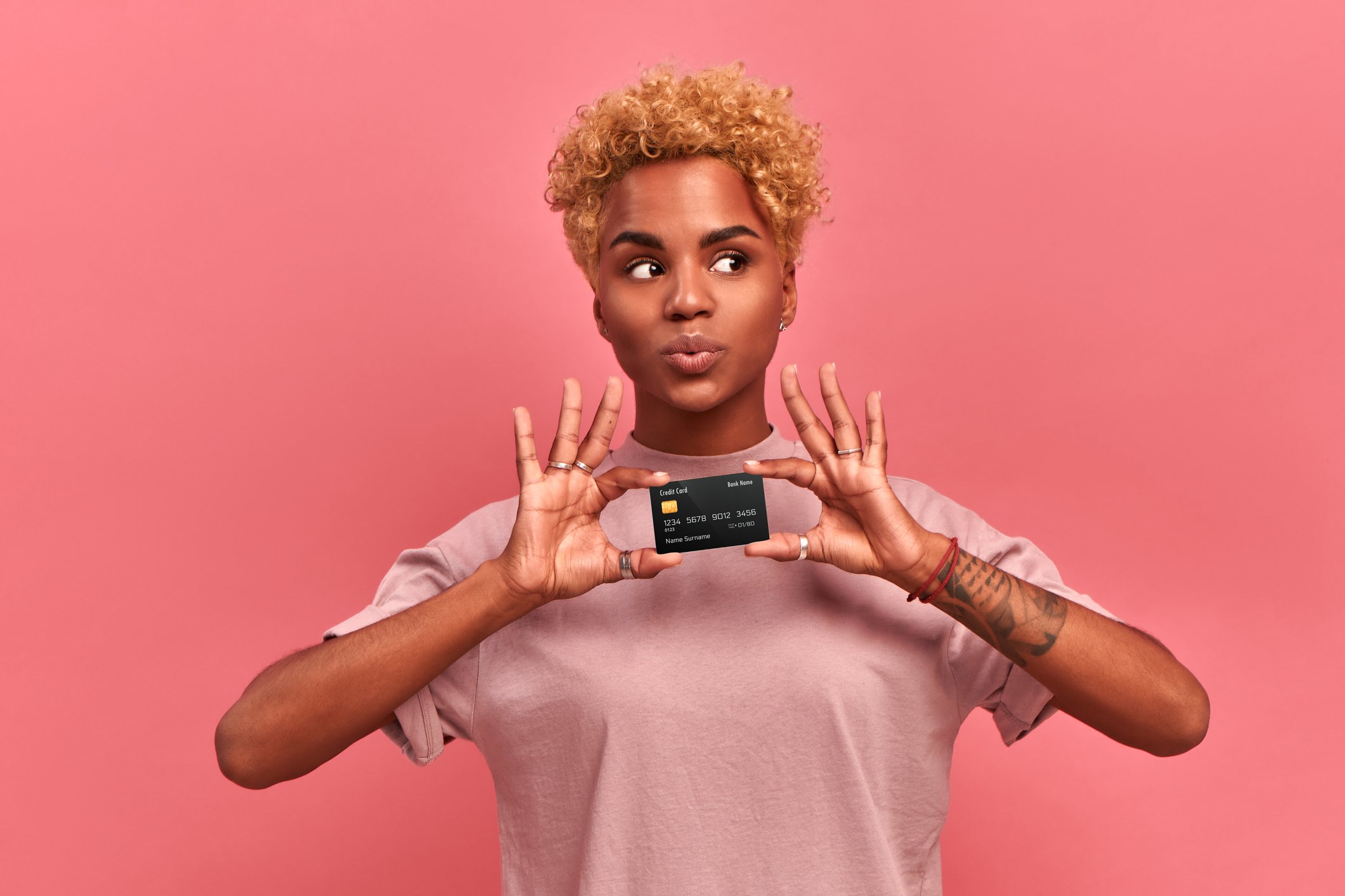 Young person holding a credit card.