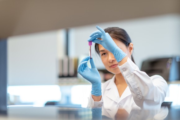 A researcher checking a sample in a lab.