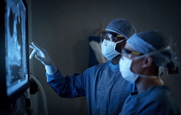 Surgeons looking at an image.