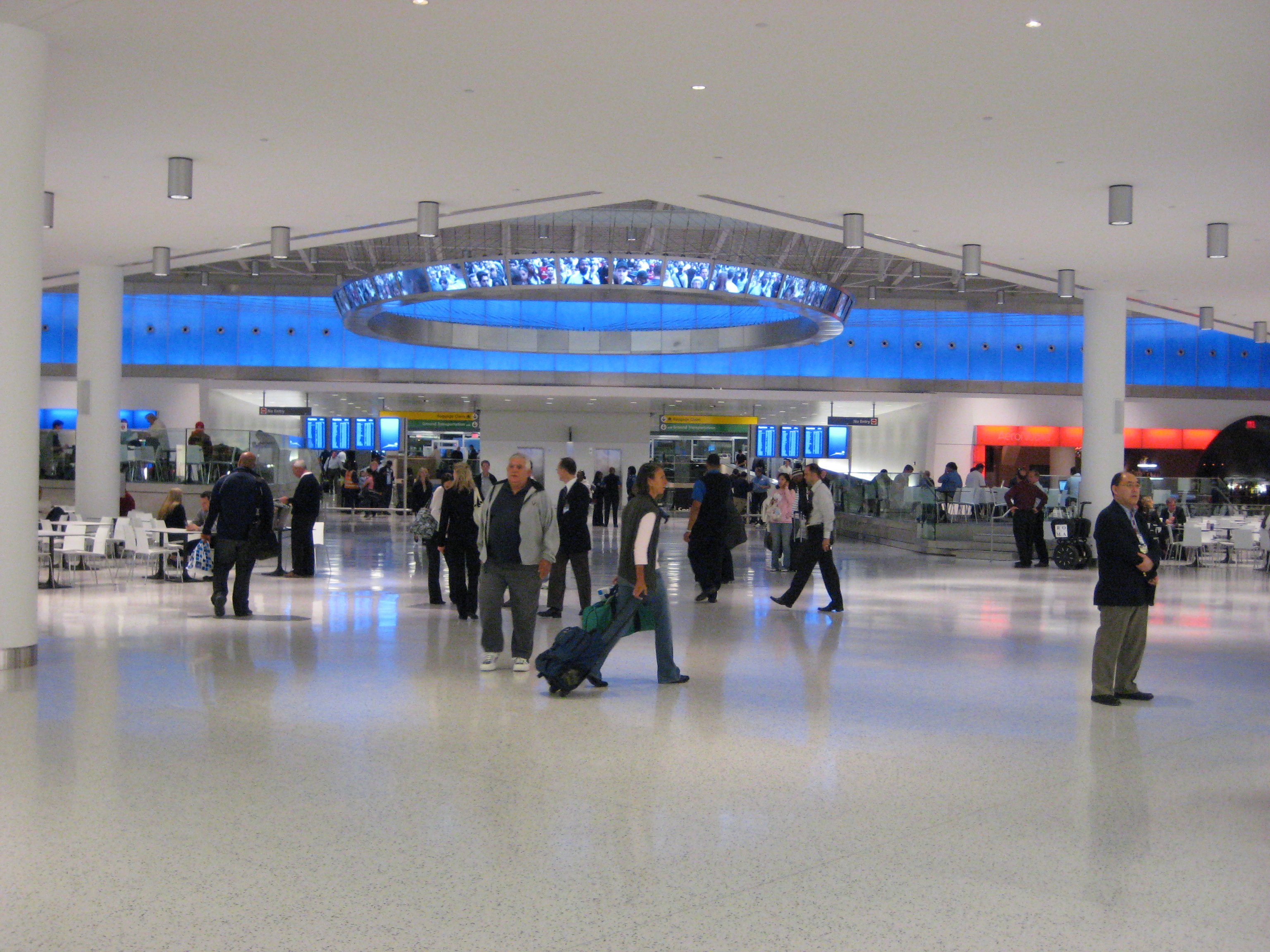 People walking through JetBlue's terminal at JFK Airport.