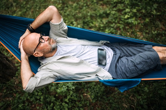 Person relaxing in a hammock.