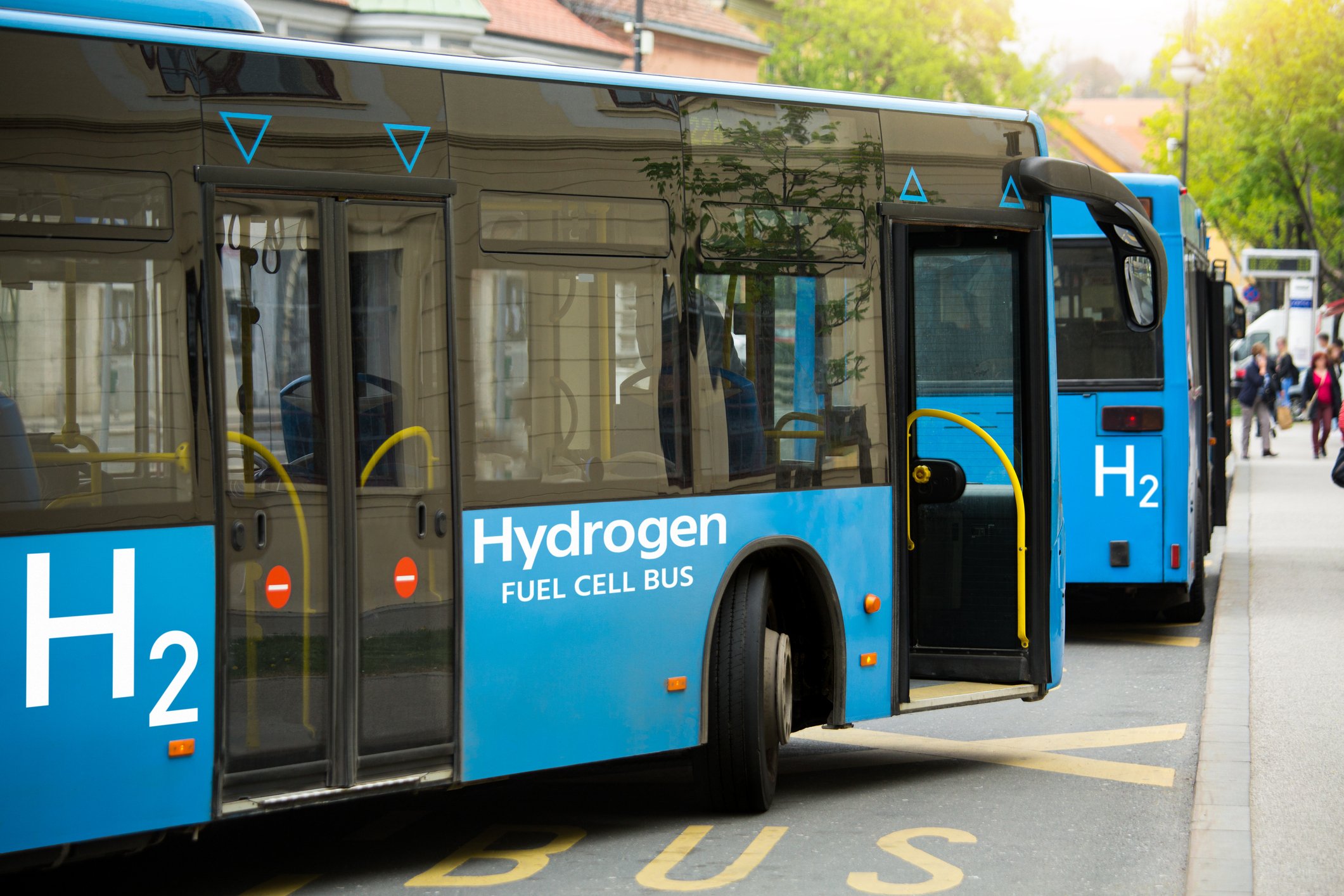 Hydrogen fuel cell buses on a road.