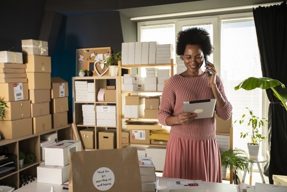 A person prepares to ship merchandise from their home.