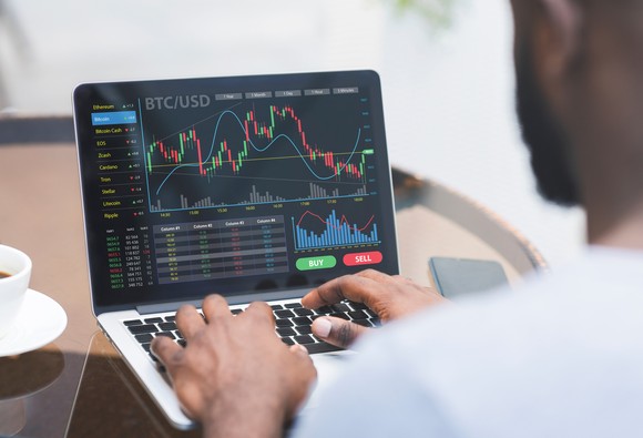 Analyzing Bitcoin price chart on laptop.