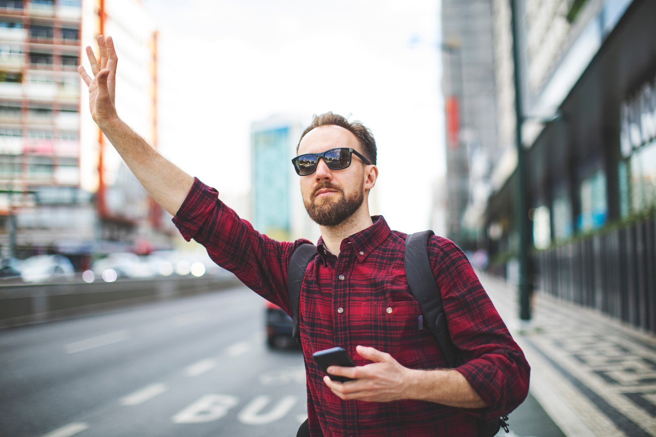 Person catching a ride-hail in a city.
