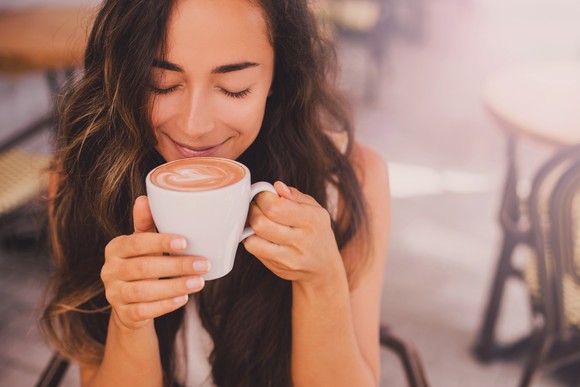 Person enjoying a cup of coffee.