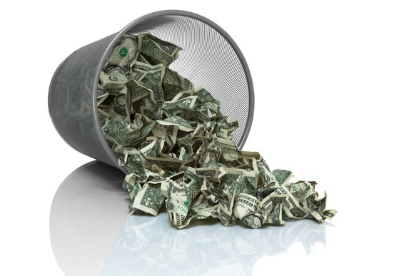 Money falling out of a garbage can.