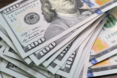 $100 U.S. banknotes stacked over one another