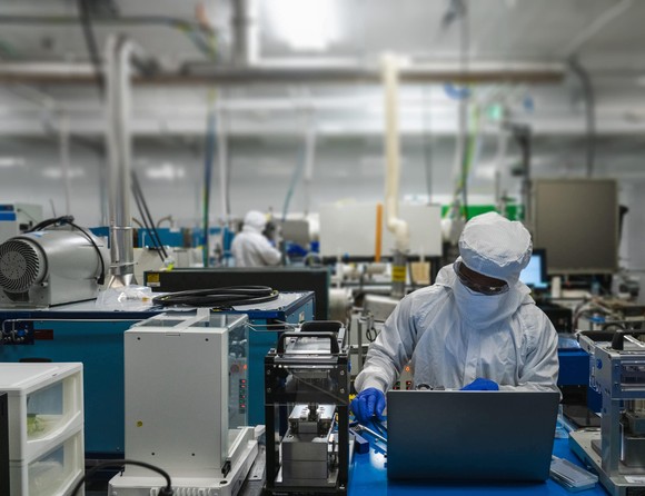 worker in tyvek suit working in QuantumScape lab.