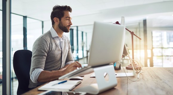 A person using a computer in an office.