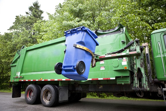 Recycling truck handling a recycling bin.
