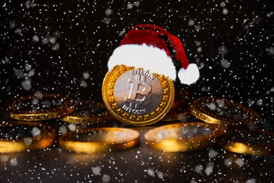 Bitcoin wearing a Santa cap in the snow.