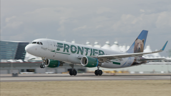 A Frontier Airlines plane landing on a runway.