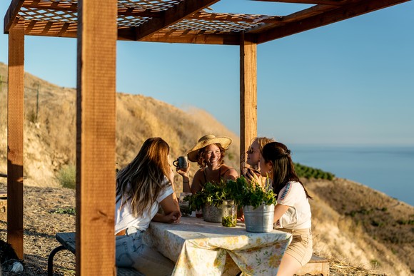 Four friends sitting together outside.