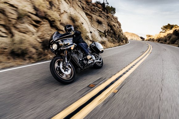 A person is riding a Harley-Davidson motorcycle. 