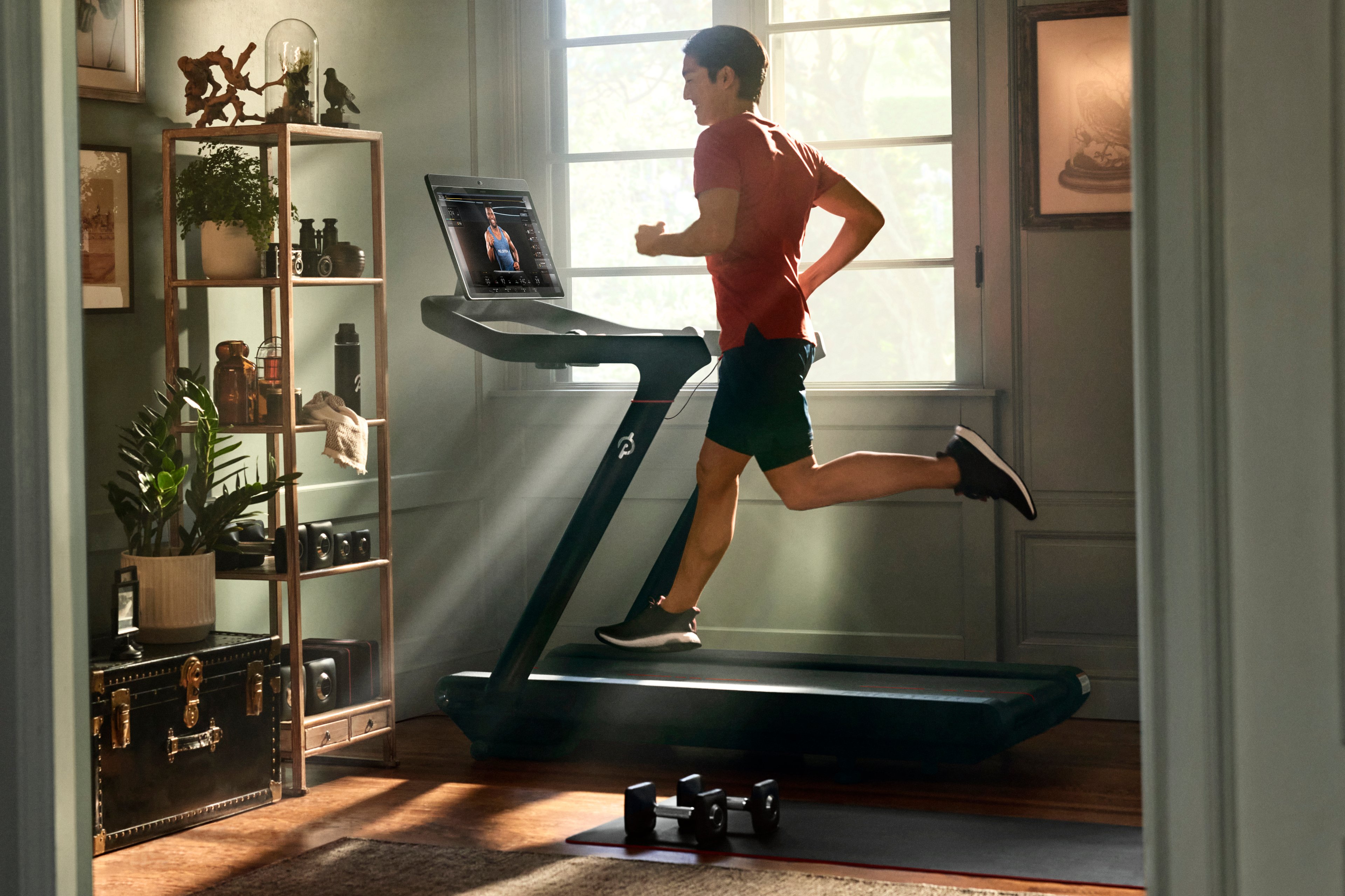 A man running on his Peloton treadmill. 