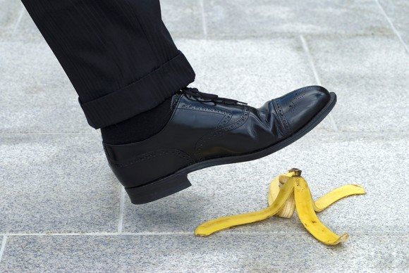 Person about to step on and slip on a banana peel. 