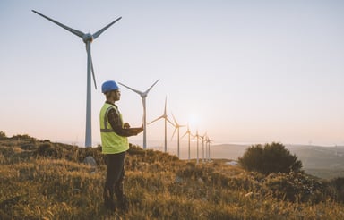 An engineer works at a wind turbine power station