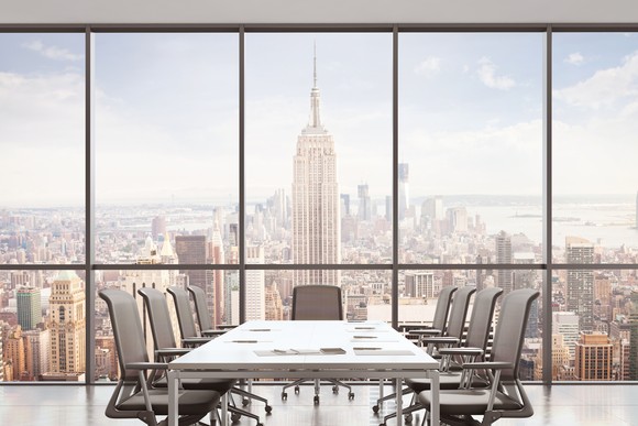 Empty office table overlooking New York City skyline.
