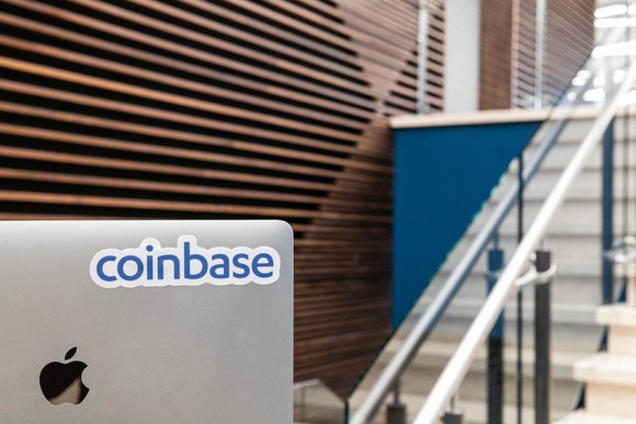 Coinbase sticker on the back of a computer monitor.