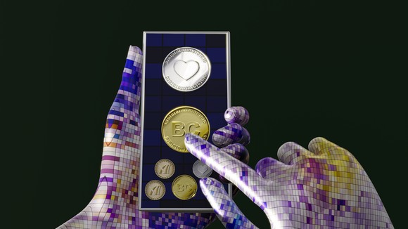 Hand holding a smartphone with cryptocurrencies displayed on the screen.
