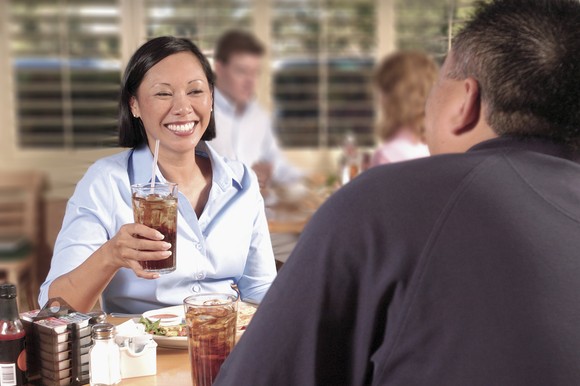 People eating and drinking soda in a restaurant.