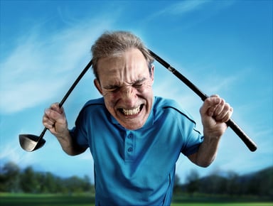 Angry golfer bends a golf club over his head.