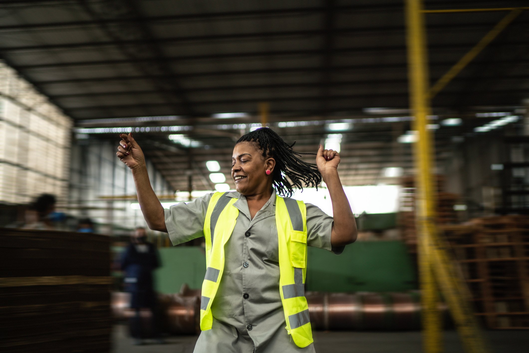 A person working in a factory looks happy.