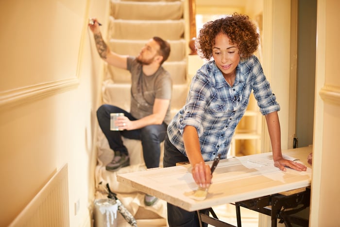 Two people renovating a house.