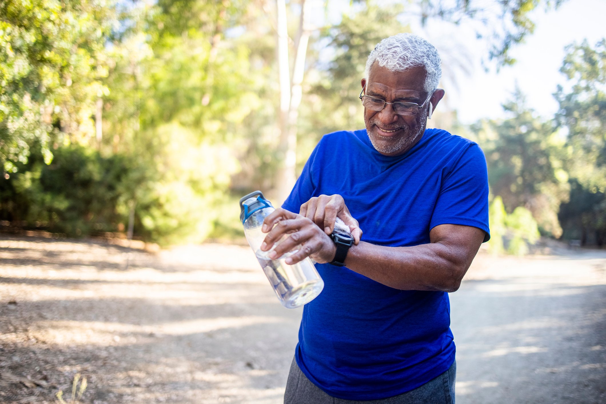A jogger checks their fitness tracker.