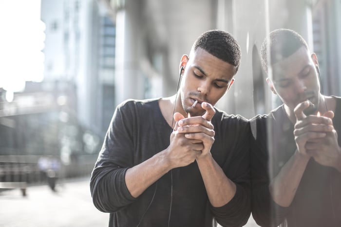 A person smokes a cigarette.