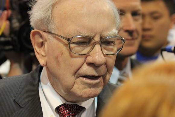 Warren Buffett talking with reporters.