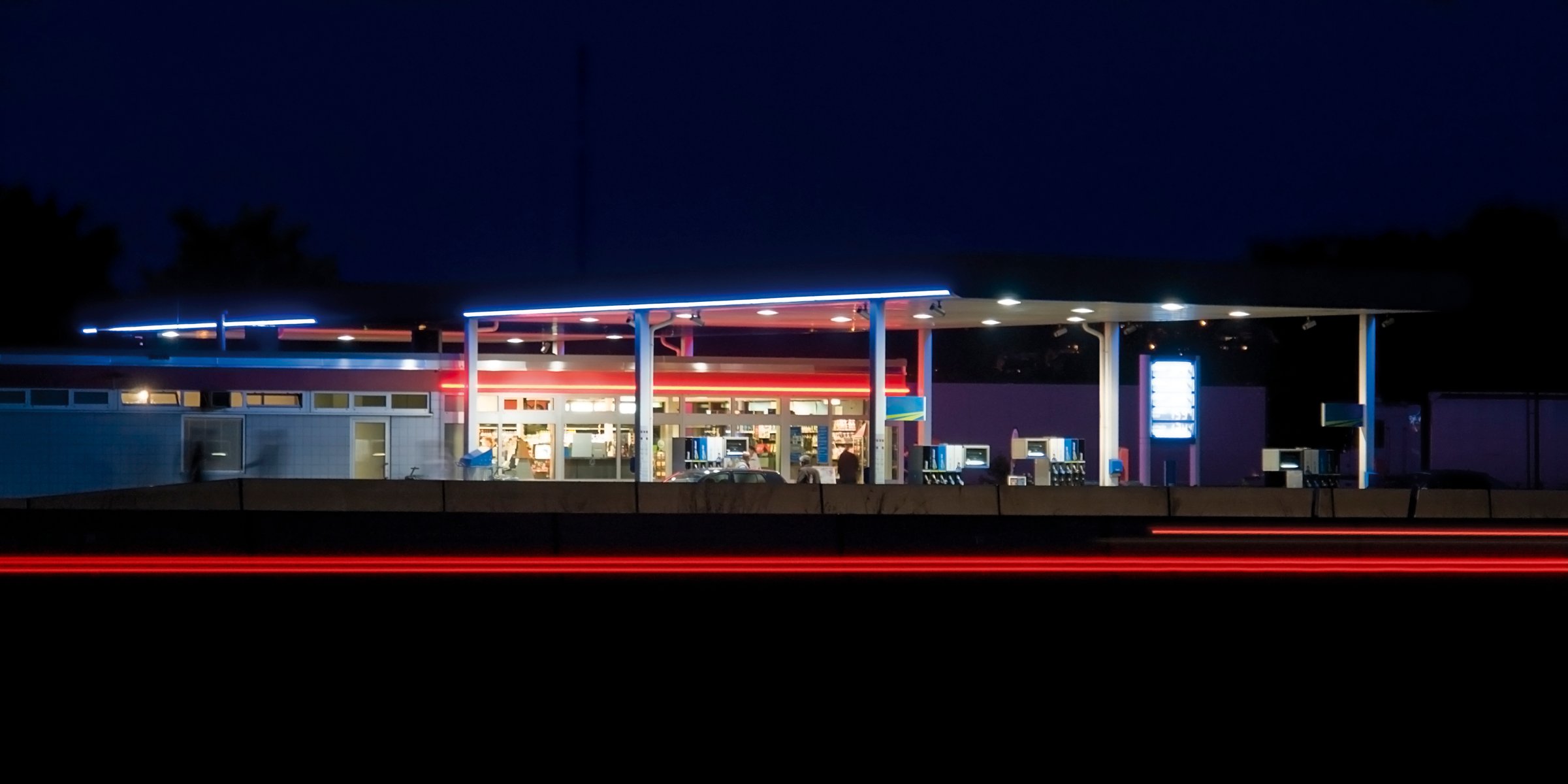 A gas station is seen with its lights on in this image taken after dark..