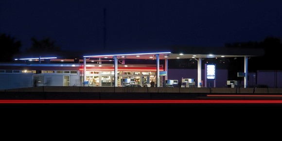 A gas station is seen with its lights on in this image taken after dark..