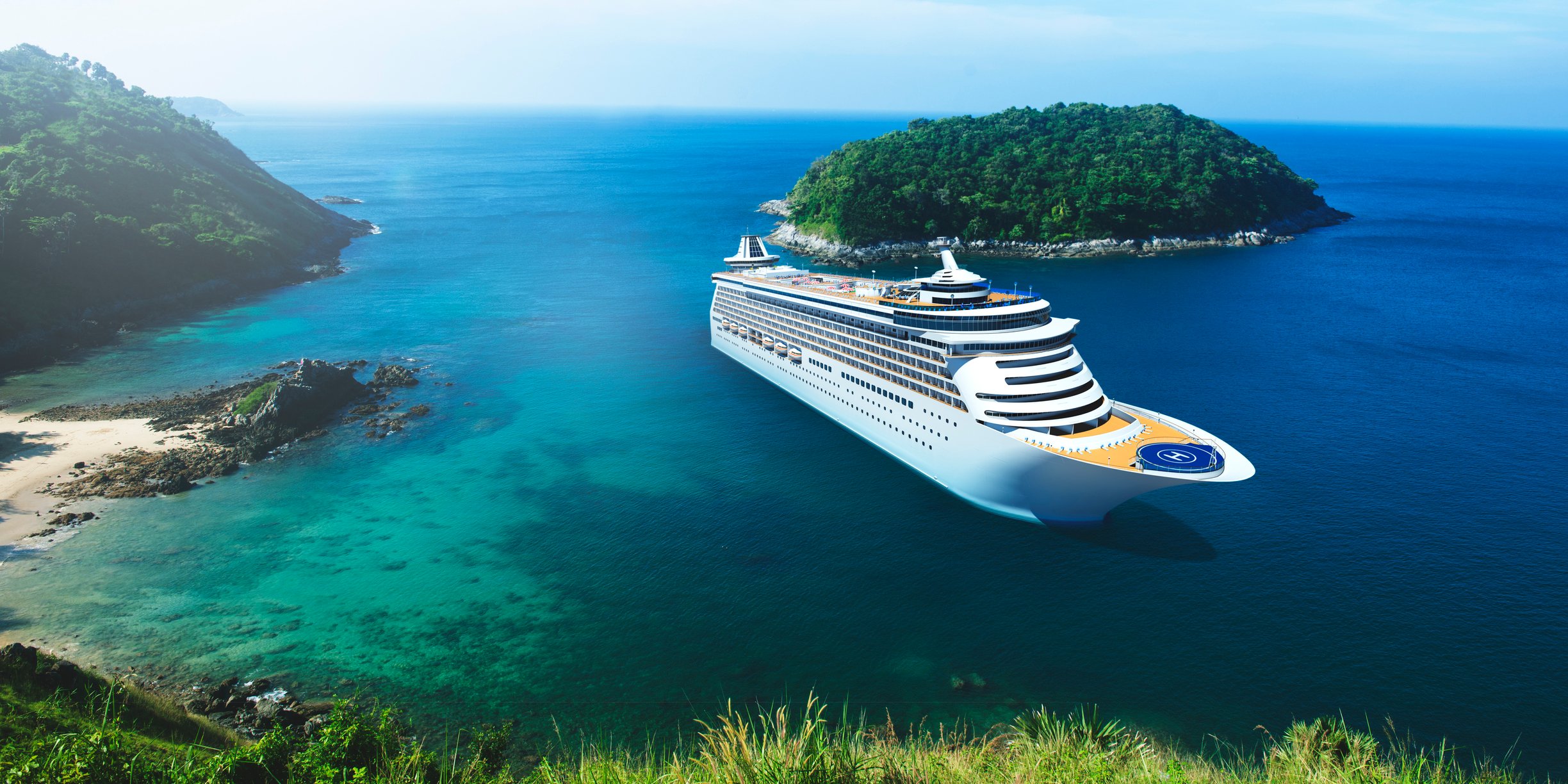 A cruise ship near a coastal area with a small, tree-covered island in the background.