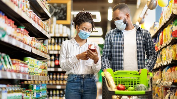 Two people shop at a grocery store.