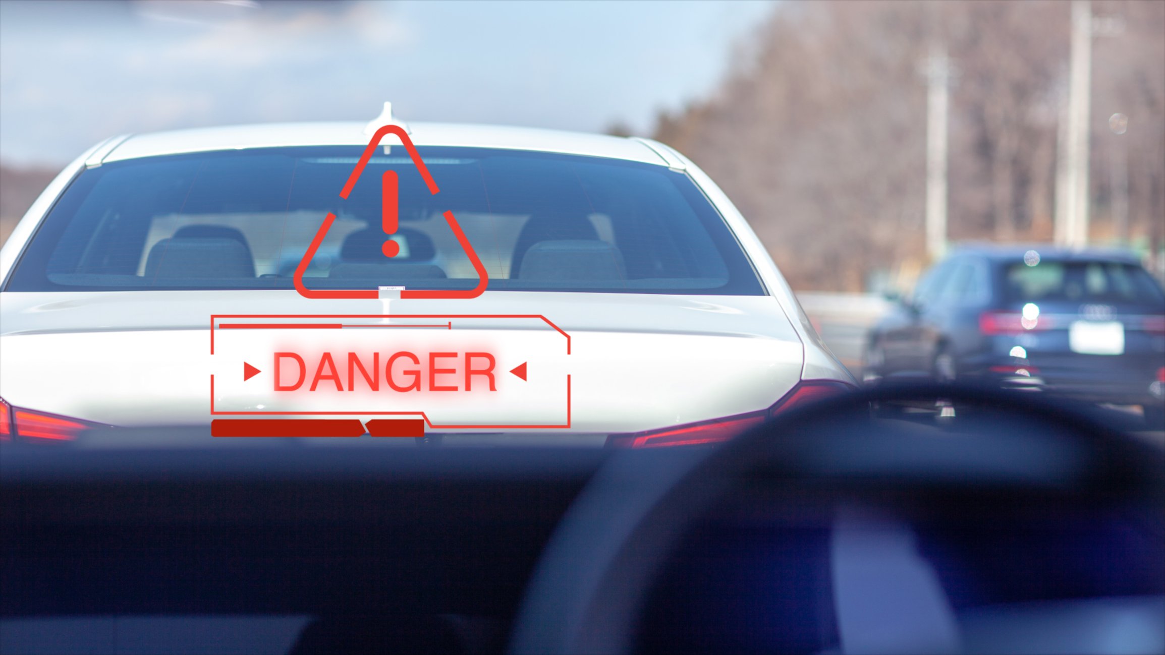vehicle showing danger symbol on windshield as it approaches to close to car ahead.