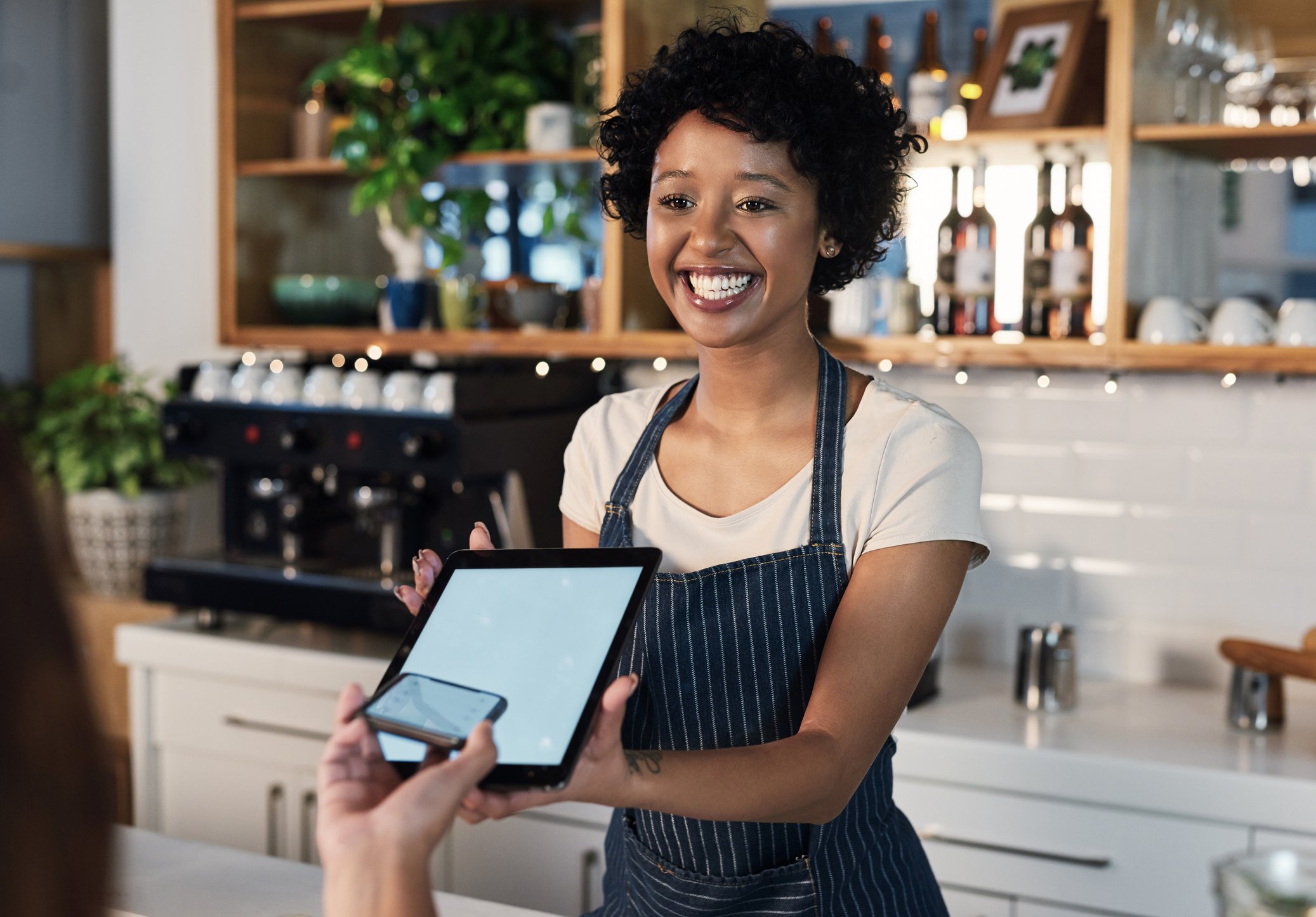 Cashier accepting digital payment from customer.