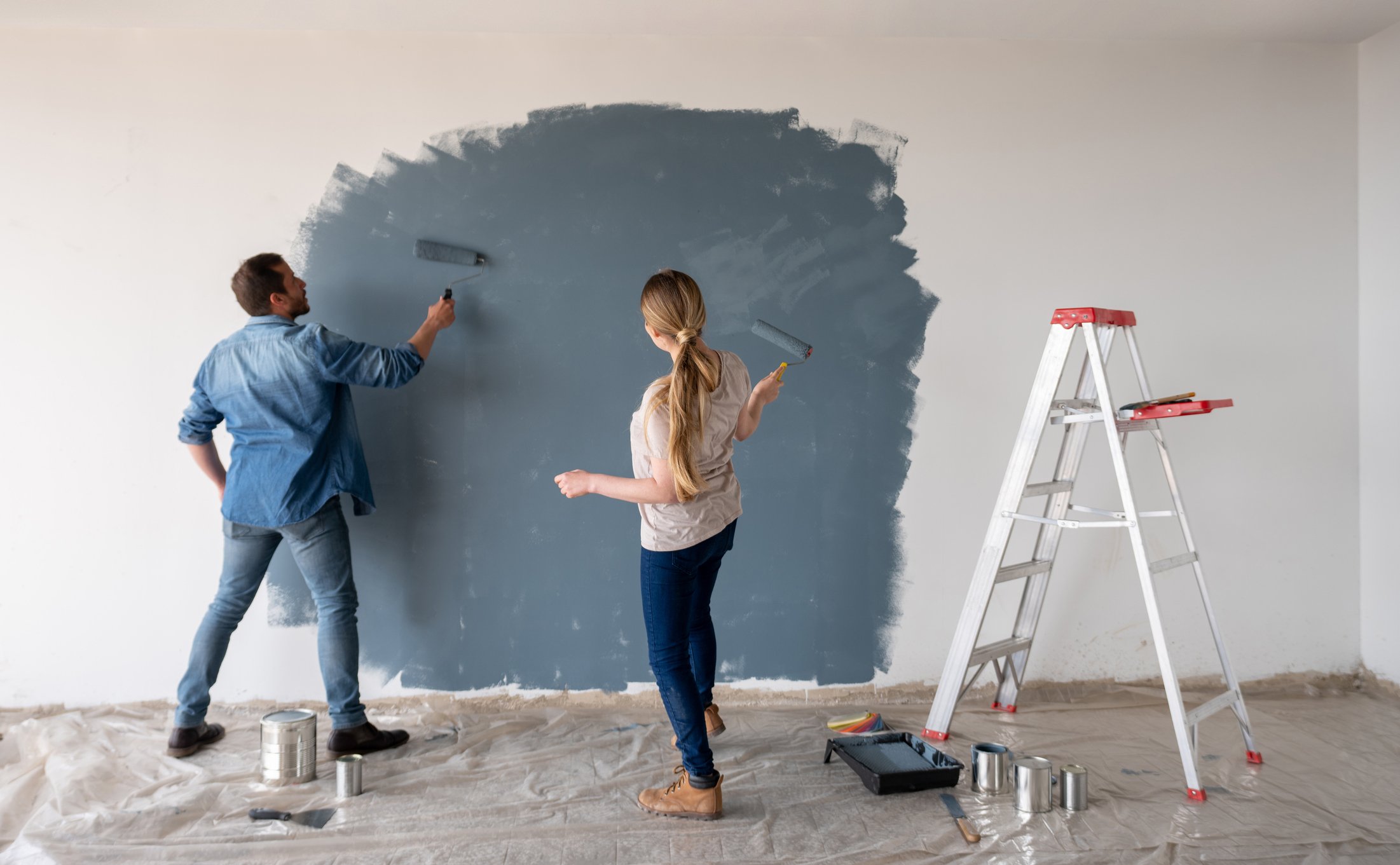 People painting a wall.