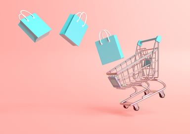 Gifts falling into a miniature shopping cart.