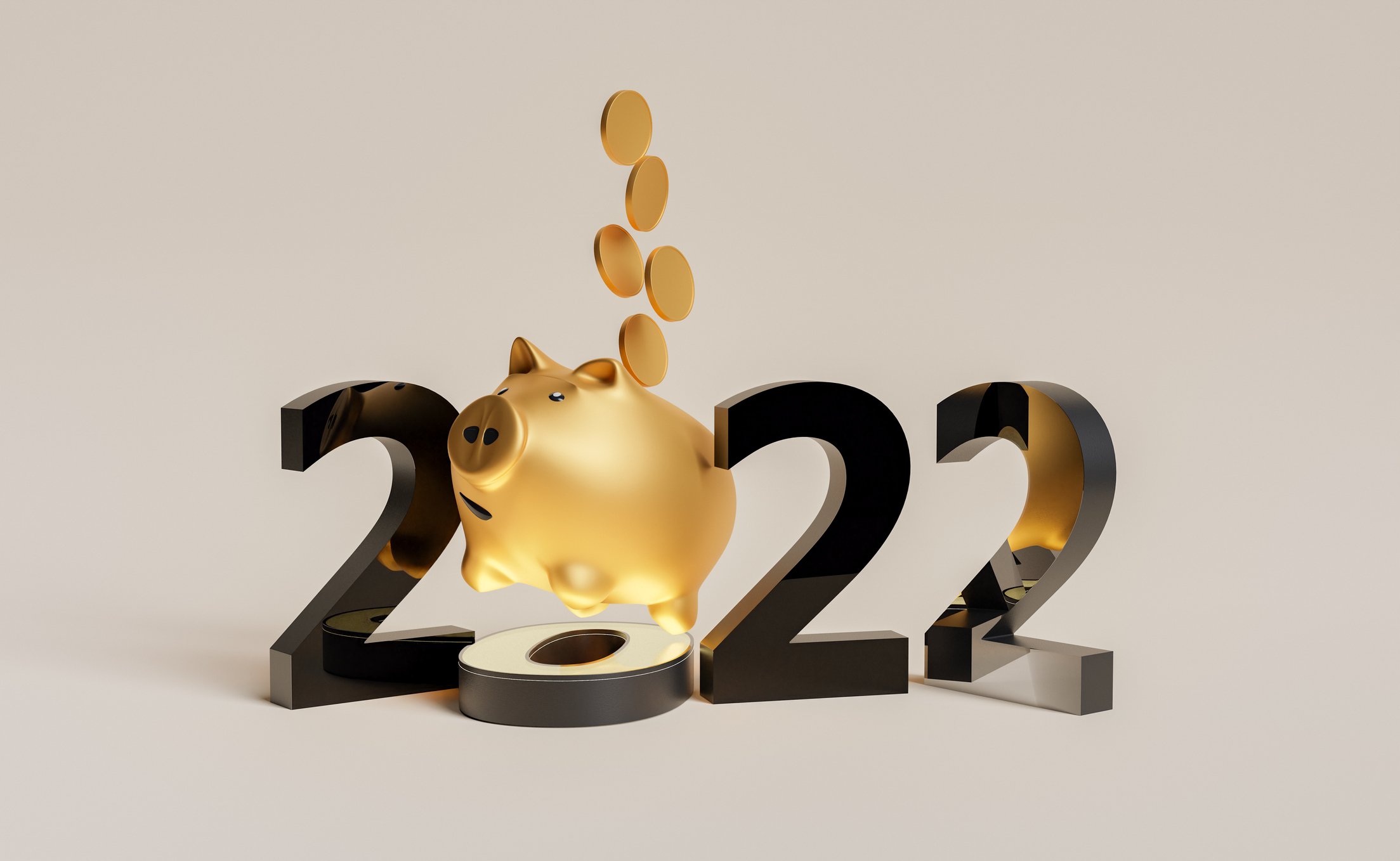 Coins dropping into a piggy bank and the number '2022.'