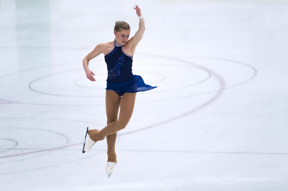 Figure skater jumping on the ice.