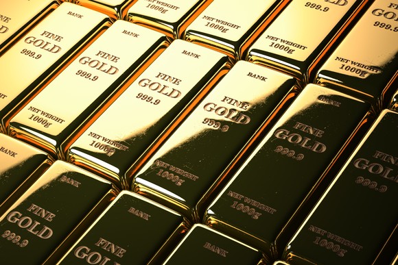 Stacks of gold bars marked FINE GOLD 1000g.