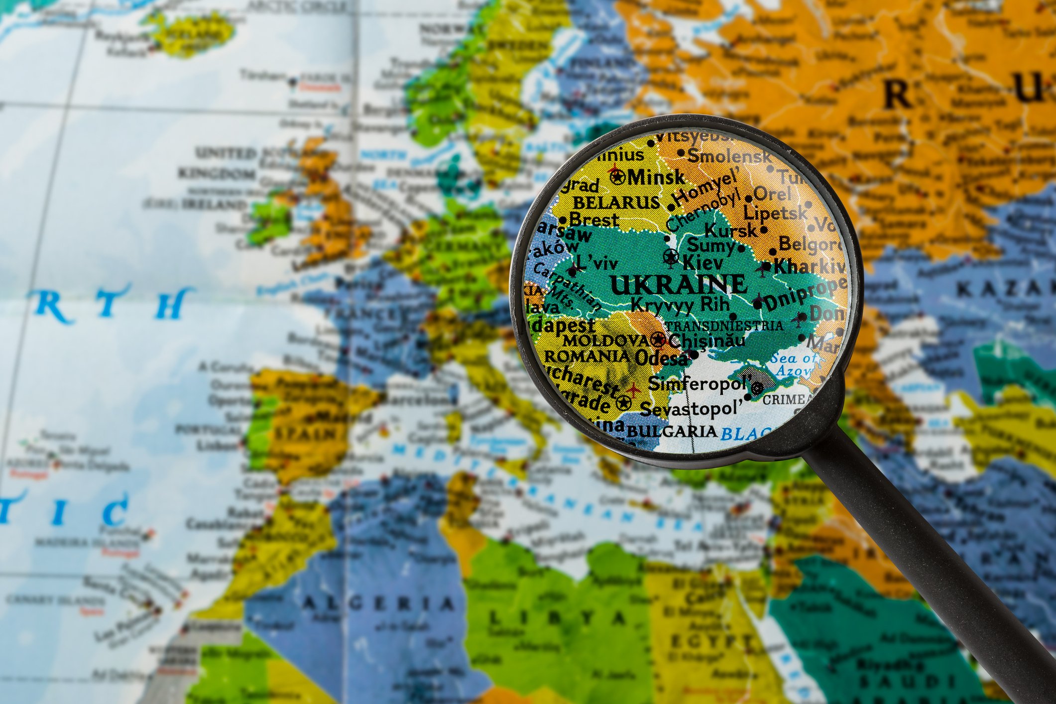 Magnifying glass over Ukraine on a map. 
