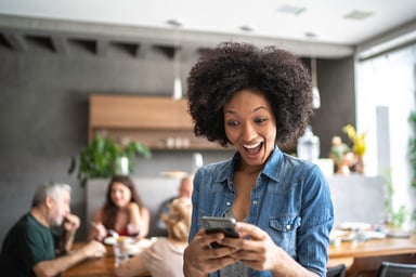 Surprised woman looking at phone